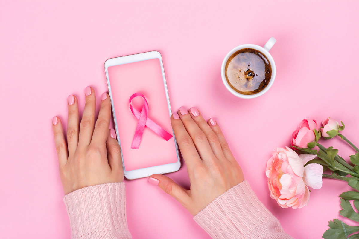 Woman Holding Smartphone with Pink Ribbon 